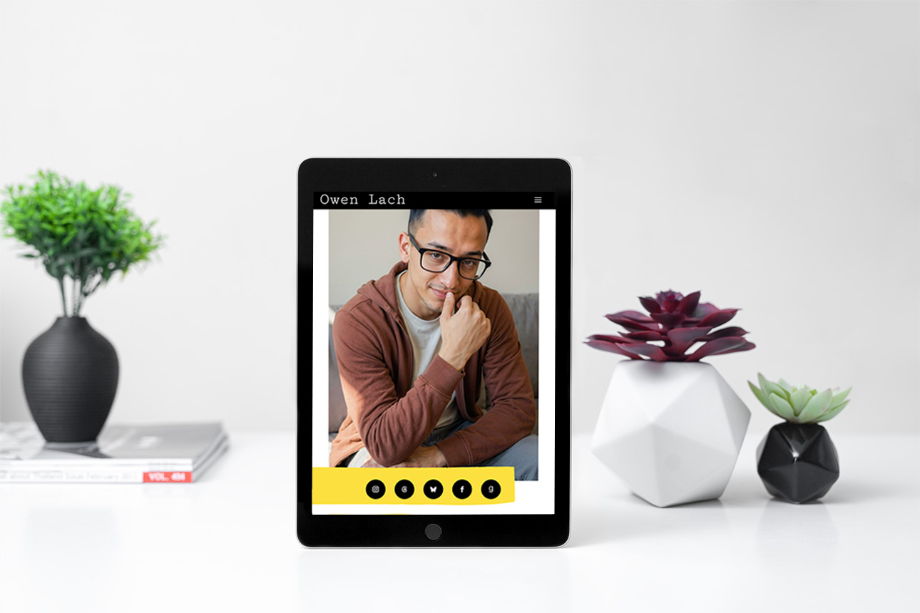 Screenshot of lachwrites.com on an ipad next to plants
